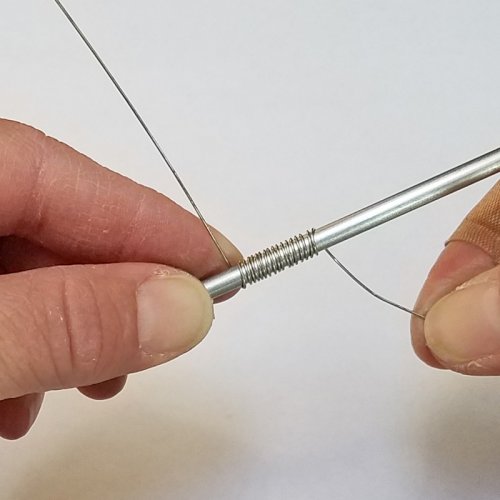 Debbie Blair's Ice Skater Necklace - , Contemporary Wire Jewelry, Coiling, Coiling Wire, Wire Coiling, Loops, Wire Loop, Wrapped Wire Loop, Stamping, Stamps, Use one hand to wrap the wire tightly around the mandrel