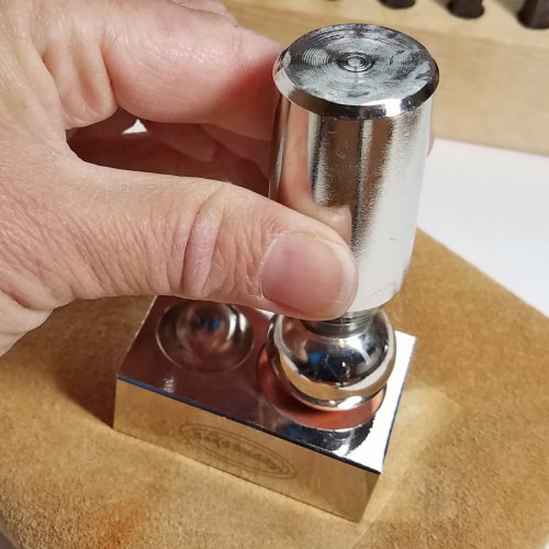 Debbie Blair's Adobe Sun Necklace - , Contemporary Wire Jewelry, Coiling, Coiling Wire, Wire Coiling, Dapping, Dapping Jewelry, How To Punch Holes, Hole Punching, Punch A Hole, Loops, Wire Loop, Wrapped Wire Loop, Beads, Place the corresponding punch on top of the copper washer.