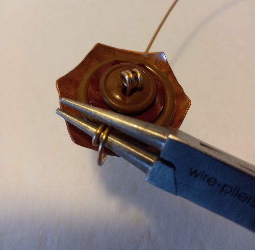 Judy Freyer Thompson's Stacked Button Charms - , Contemporary Wire Jewelry, Cutting, Cutting Tool, Cutters, Dapping, Dapping Jewelry, How To Punch Holes, Hole Punching, Punch A Hole, Loops, Wire Loop, Wrapped Wire Loop, Sawing, Saw, Wire Saw, Butane Torch, Soldering, Solder, Use the round nose pliers to make a few coils