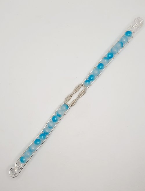 Natalie Patten's Interlocking Coil Bangle - , Contemporary Wire Jewelry, Coiling, Coiling Wire, Wire Coiling, Use round nose pliers to create a swirl at each end of the bangle.    