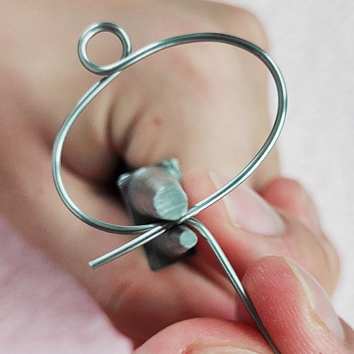 Mei Tan's All Seeing Eye Pendant - , Contemporary Wire Jewelry, Wire Wrapping, Wrapping, Wire Wrapping Jewelry, Use round nose pliers to bend each end down 90 degrees from the bottom of the shell.    