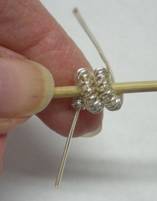 Judy Larson's How to Make a Wire Coil and Bead - , Findings & Components, Toggles & Clasps, Earwire & Headpin, Coiling, Coiling Wire, Wire Coiling, Findings, Clasps, Components, Wire Wrapping, Wrapping, Wire Wrapping Jewelry, wire wraps around to the right of center and to the front.