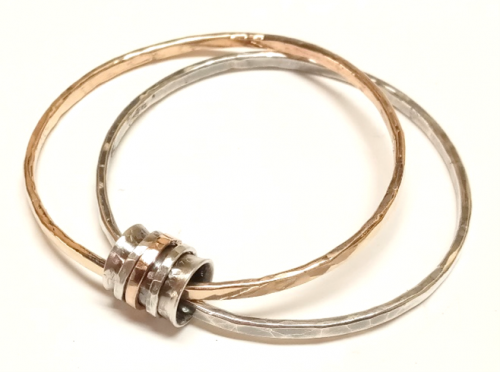 Judy Larson's Spinner Fidget Bangles, Contemporary Wire Jewelry. Texturing. This bi-metal bangle made with Argentium and gold-filled wire is sure to be a complement to all your single bangles.