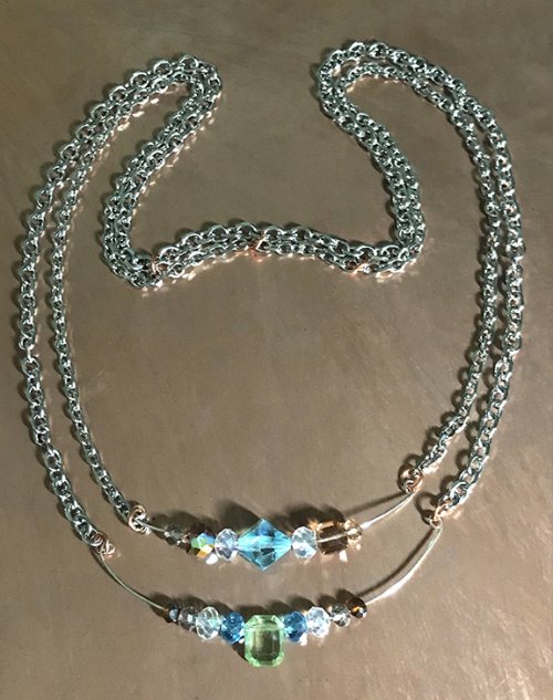 Nancy Chase's The Bend Necklace, Contemporary Wire Jewelry. Loops, Wire Loop, Wrapped Wire Loop. This curvy double wire chain necklace is centered with sparking crystal beads of different shapes and sizes.