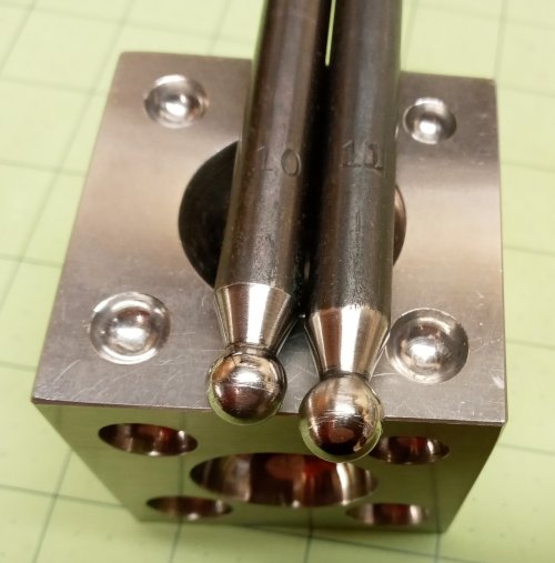 Judy Larson's Bead Cap Primer - Form the bead caps:, Wire Jewelry Design, Dapping, Dapping Jewelry, Filing, Finishing, How To Punch Holes, Hole Punching, Punch A Hole, place a disc in a larger well of a dapping block