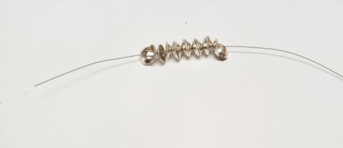 Judy Larson's Bead Cap Primer - Finishing:, Wire Jewelry Design, Dapping, Dapping Jewelry, Filing, Finishing, How To Punch Holes, Hole Punching, Punch A Hole, Flatten the crimp tube