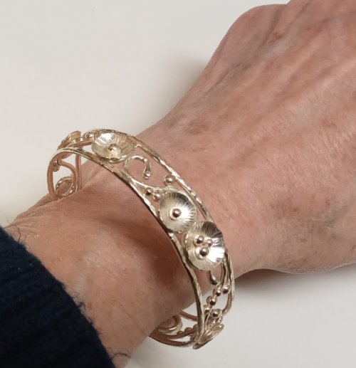 Judy Larson's Putting On and Taking Off a Cuff Bracelet - , General Education, , Push one end of the cuff into the underside