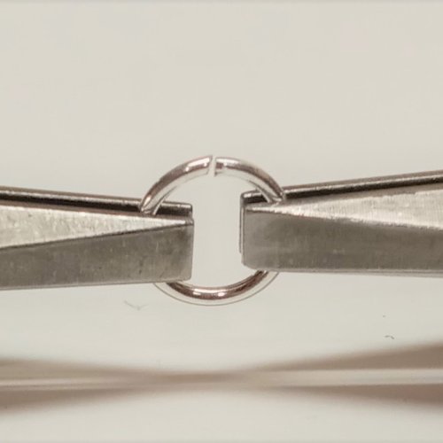 Judy Larson's Wire Basics - Opening and Closing Jump Rings - , General Education, , close up of jump ring between two pliers