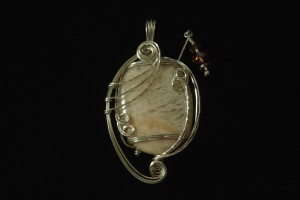 Sunstone wrapped with 21-gauge square sterling silver wire and Swarovski® accents by Deborah Hamilton