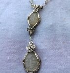 Carved Moonstone Faces wrapped in sterling silver wire by Tina Bowersox