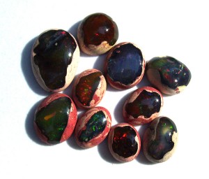 A selection of Mexican jelly/fire opal cabochons. Those that have play of color and are called precious fire opal. Private collection, Dale Armstrong.