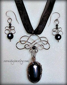 Hematite cabochon wrapped in stainless steel wire by Zoraida Bros, with matching hematite bead earrings.