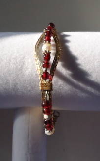 Jane Duke wire created this 14kt gold-filled bracelet with garnets and freshwater pearls.