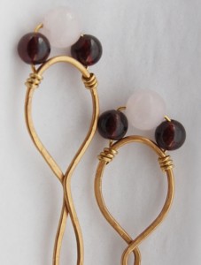 Marcia Kertel created these chignon hair pins with bronze wire, accenting with rose quartz and red garnet beads.