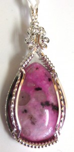 This sugilite pendant by Sherry Luke is wrapped with shining sterling silver wire.