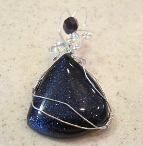 Carol Roskey wrapped this purple goldstone in sterling silver wire to form a pendant.