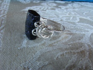 Linda Pope made this Blue Goldstone bead the focal point of a wire wrapped ring in non-tarnish silver wire.