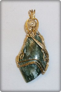 Joan Madouse wrapped this freeform seraphinite cabochon in gold-plated wire